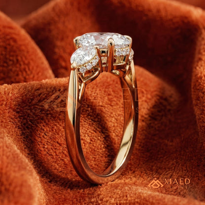 Classic Oval Cut Three-Stone Engagement Ring with Pear Side Stones in Silver, 14K Gold & Rose Gold